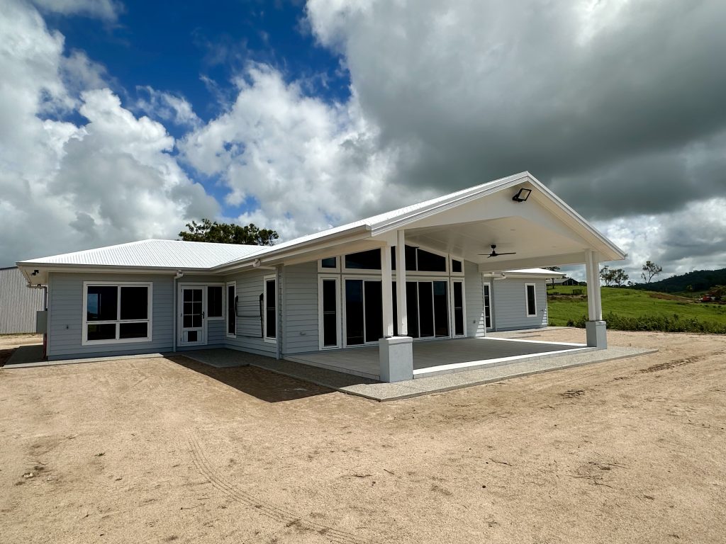 New single-storey home with a large covered patio on a cleared sandy block